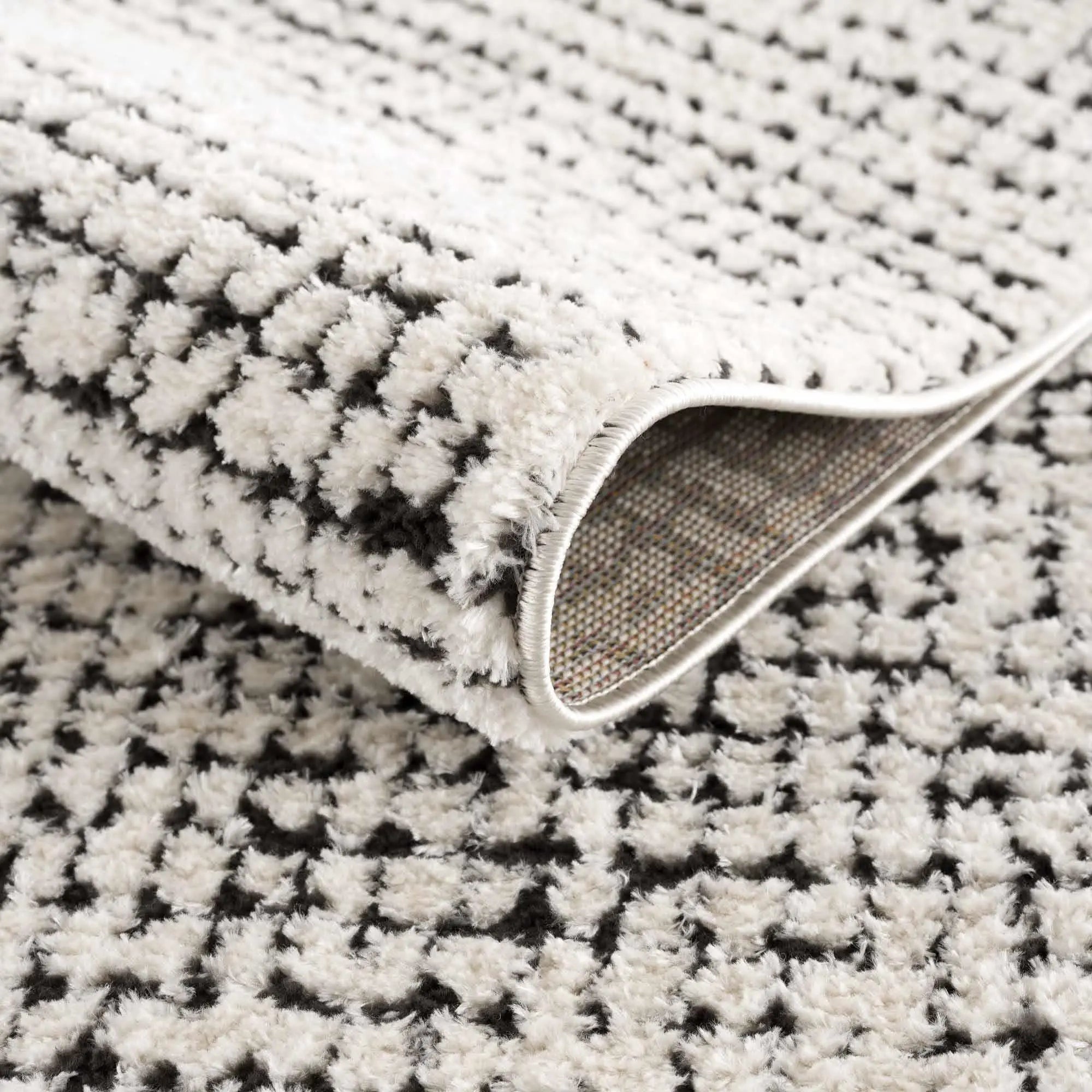 Cozy black and white patterned area rug with soft shag texture, perfect for farmhouse or cottage style home decor