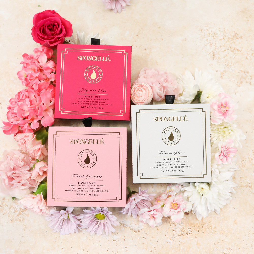 Spongellé skincare products with pink and white packaging on a floral background