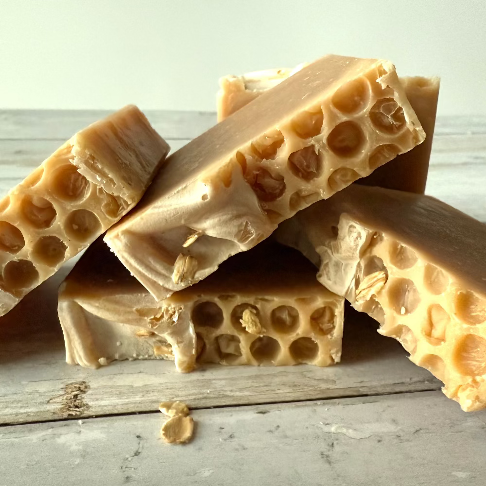 Beeswax candles with honeycomb texture on a wooden surface