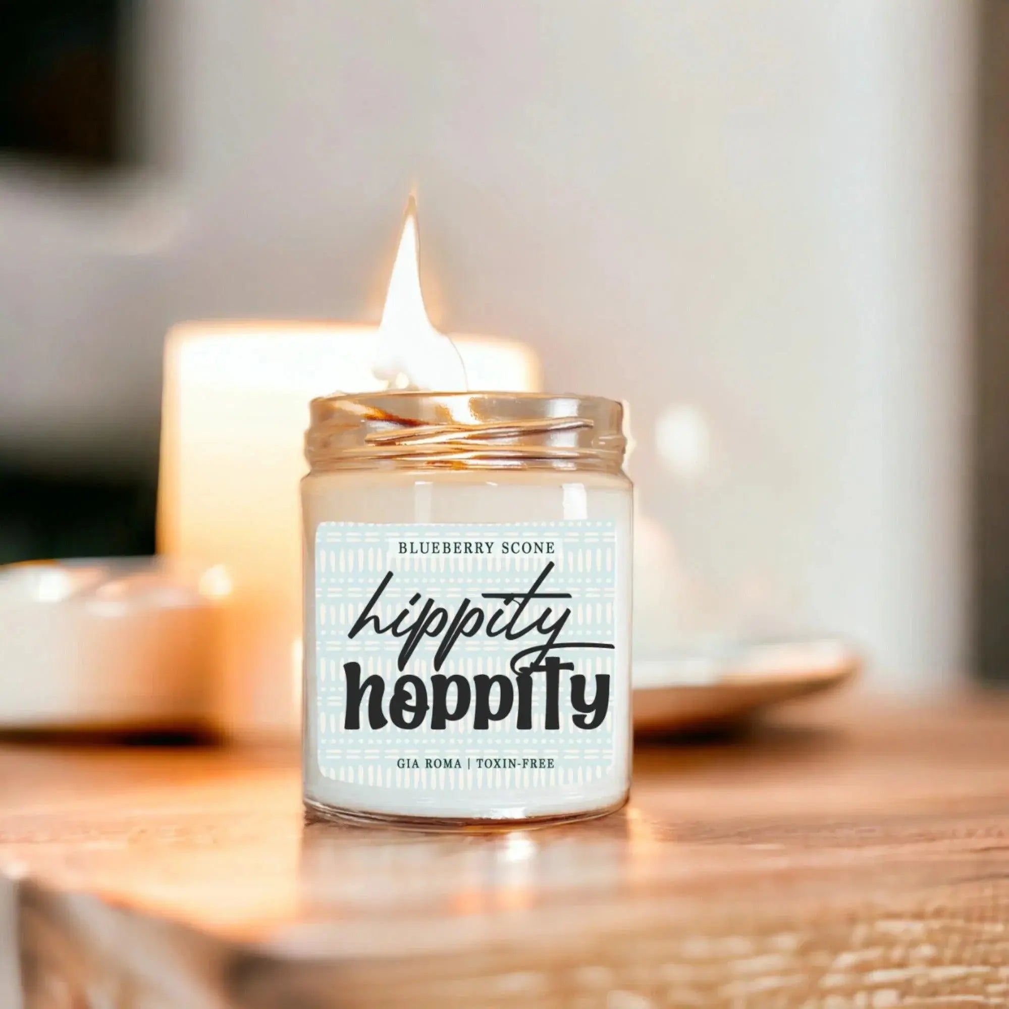 Candle in a glass jar with a label on a wooden surface