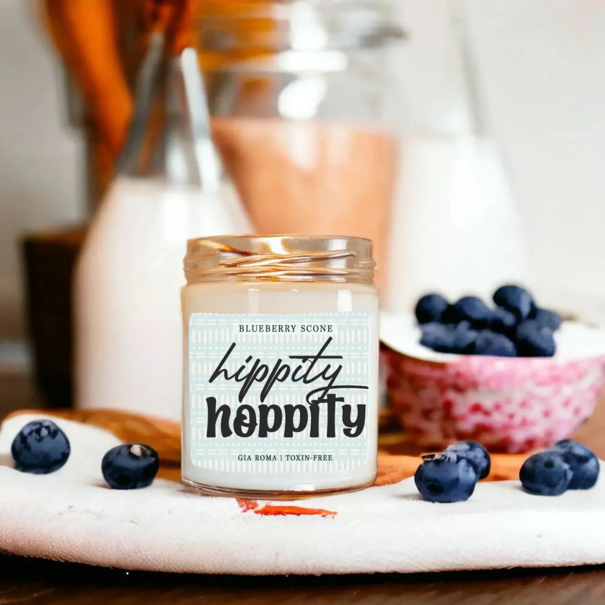 Hippity Hoppity candle with blueberries on a wooden surface
