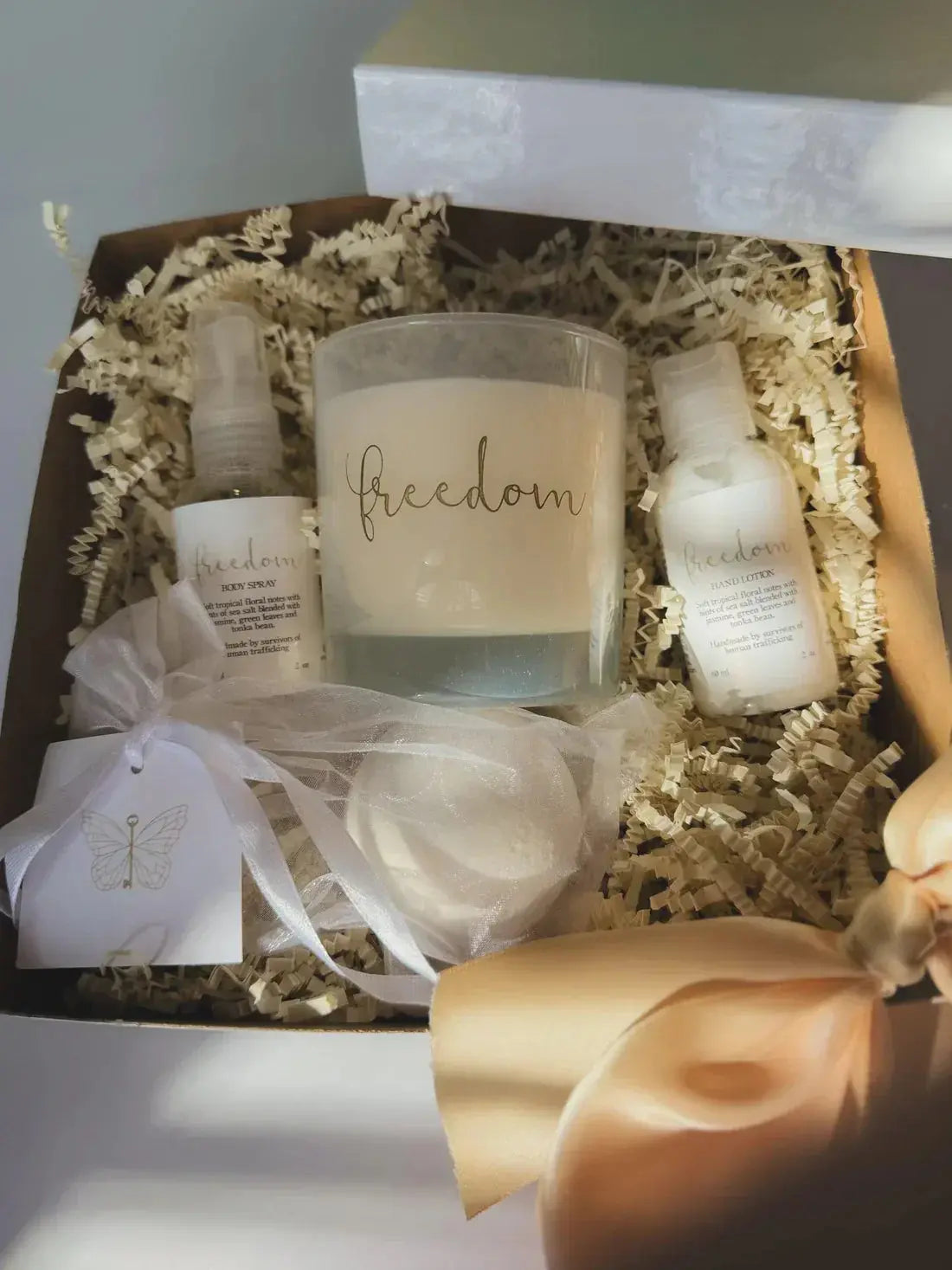 Freedom-themed candle, body spray, and hand lotion gift set in cozy farmhouse-style packaging