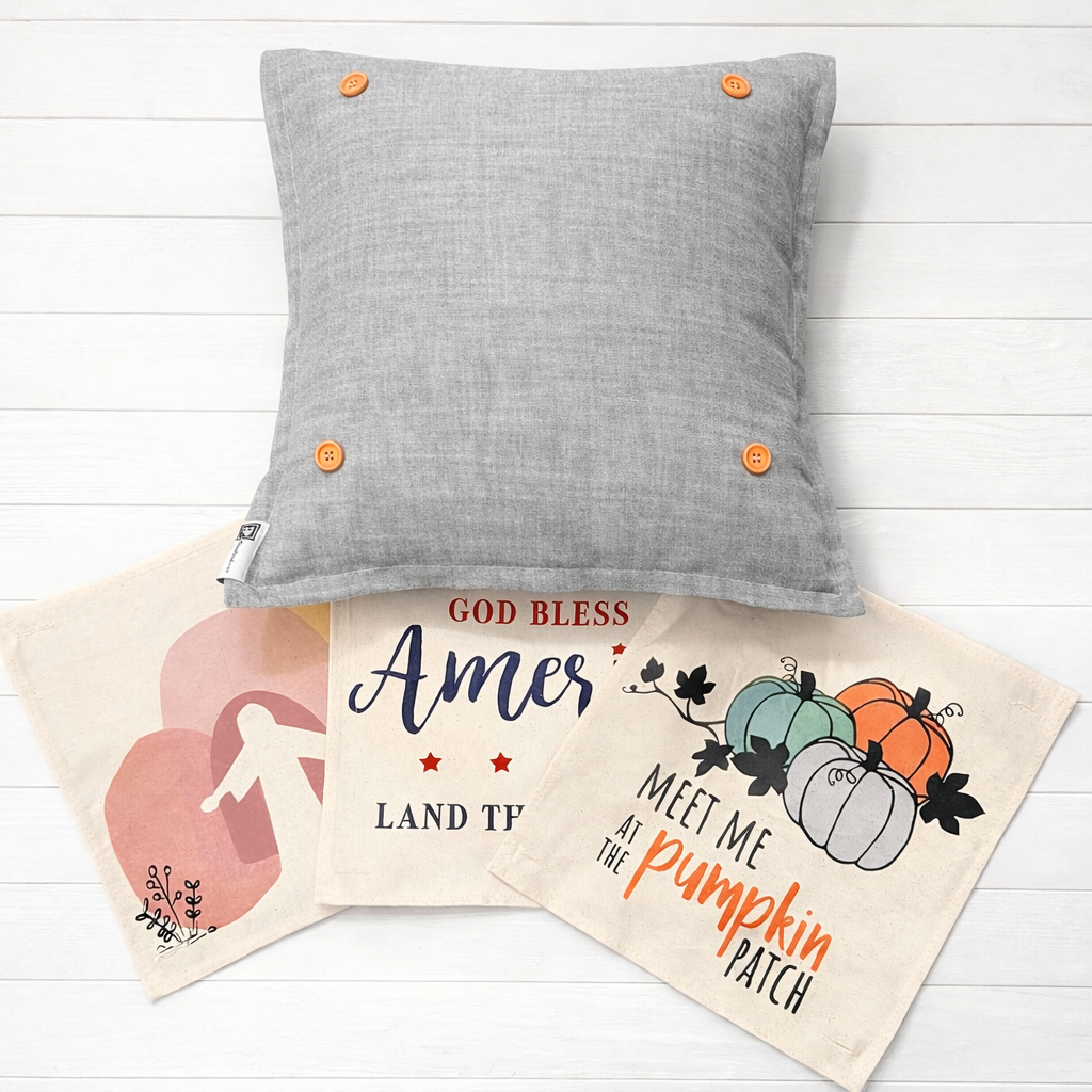 Gray pillow with orange buttons on a white wooden surface, with two decorative bags featuring text and graphics.