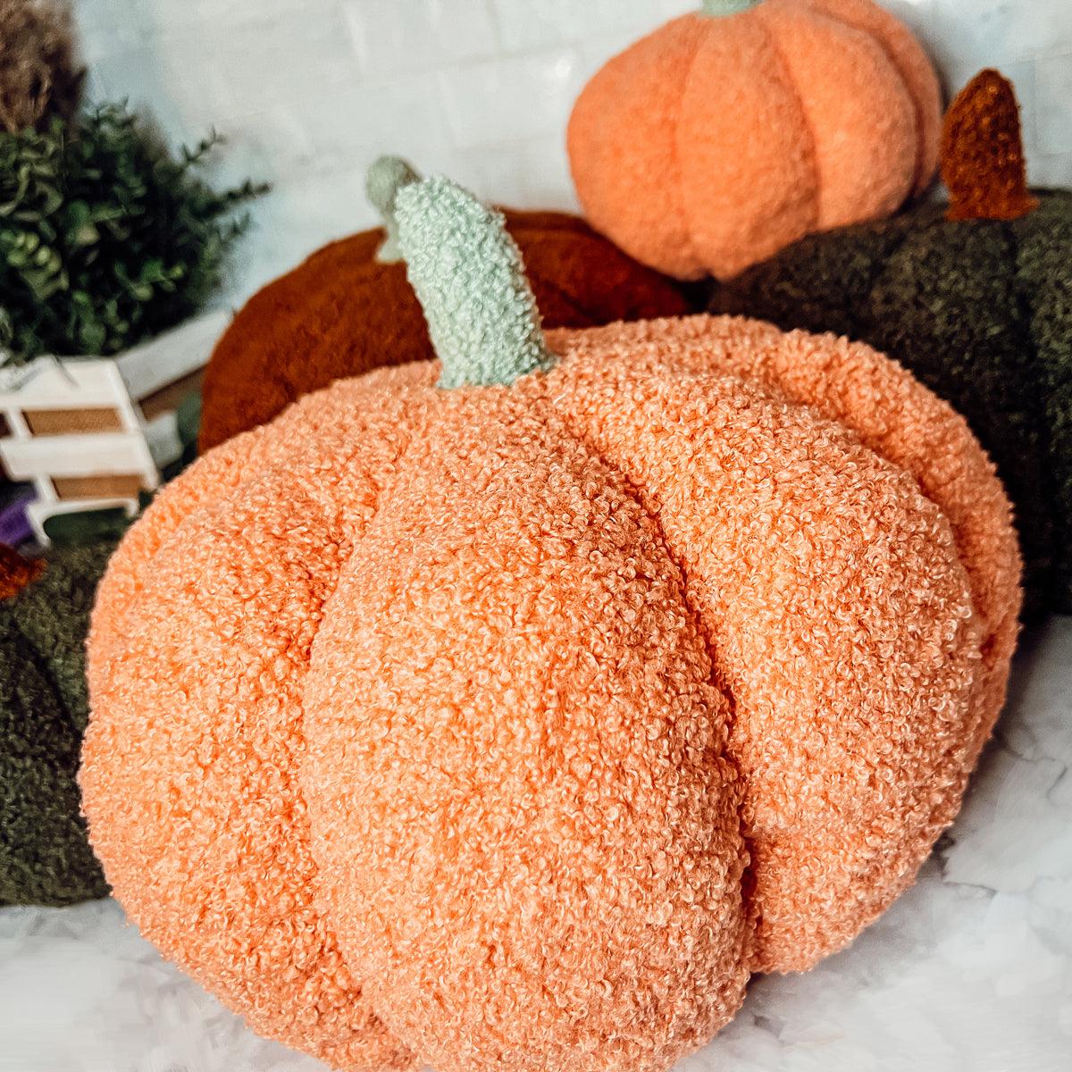 Decorative pumpkins with textured surface on a neutral background