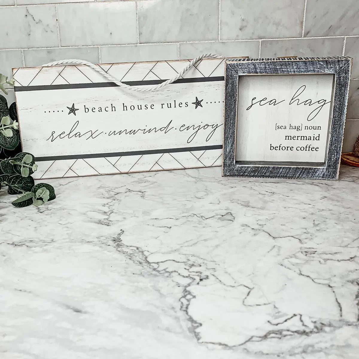 Beach house rules and sea hag decor signs on marble countertop for cozy cottage style home