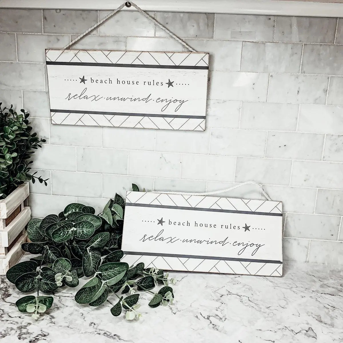 Beach house rules sign with relax unwind enjoy text, farmhouse decor on marble countertop