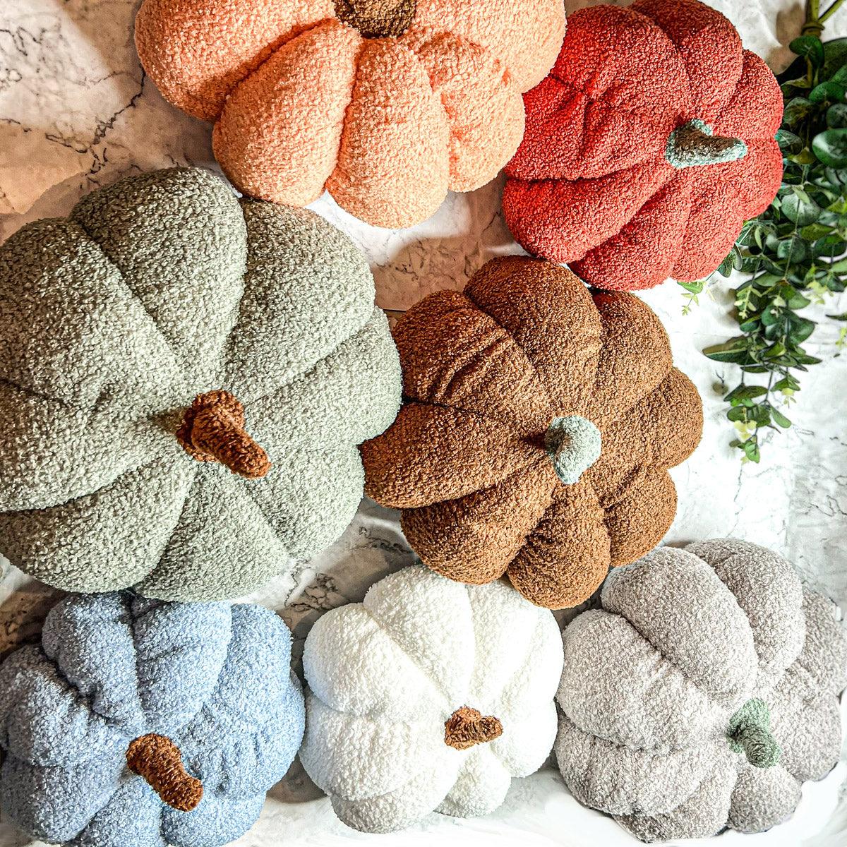Stack of multicolored textured pumpkins on a snowy background