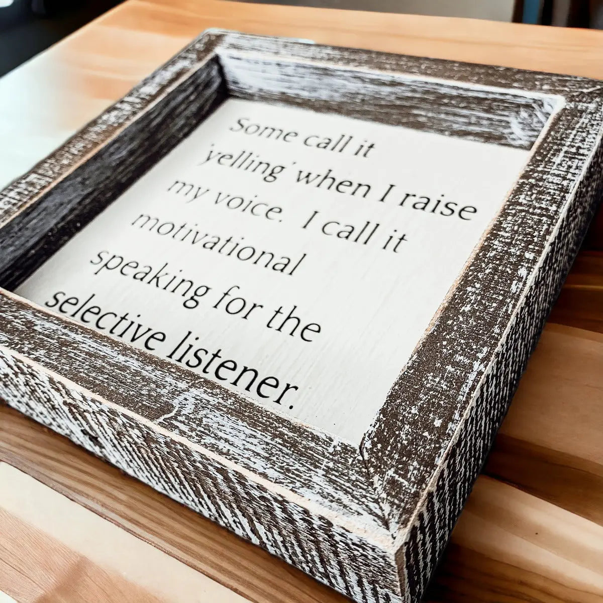 Wooden box with a motivational quote on a wooden surface