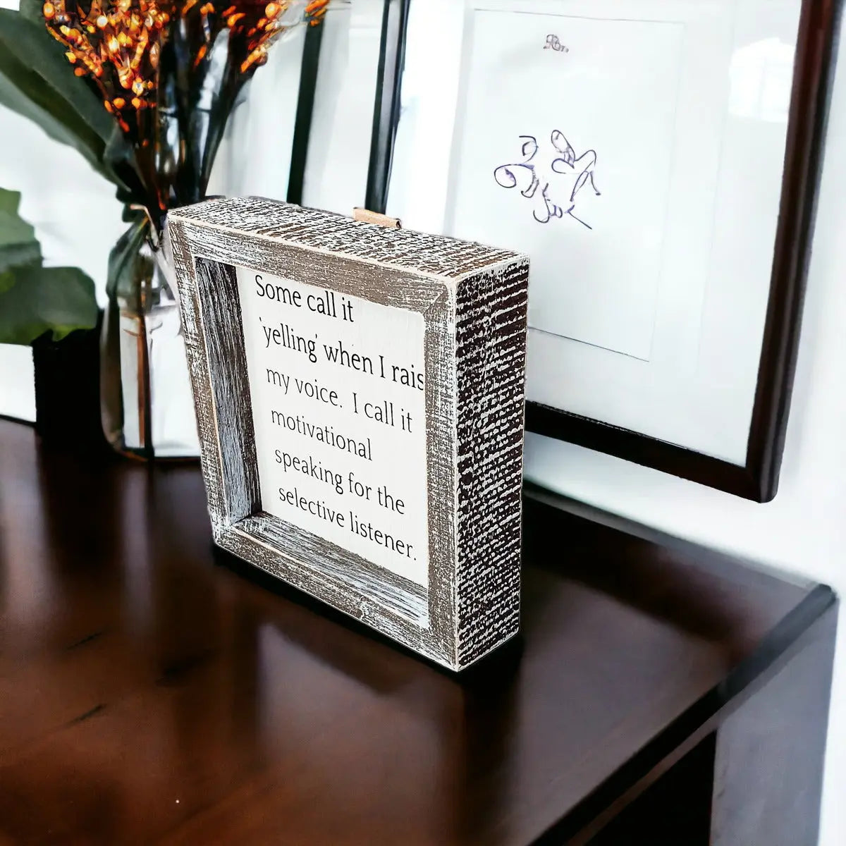 Decorative box with motivational quote on a wooden surface