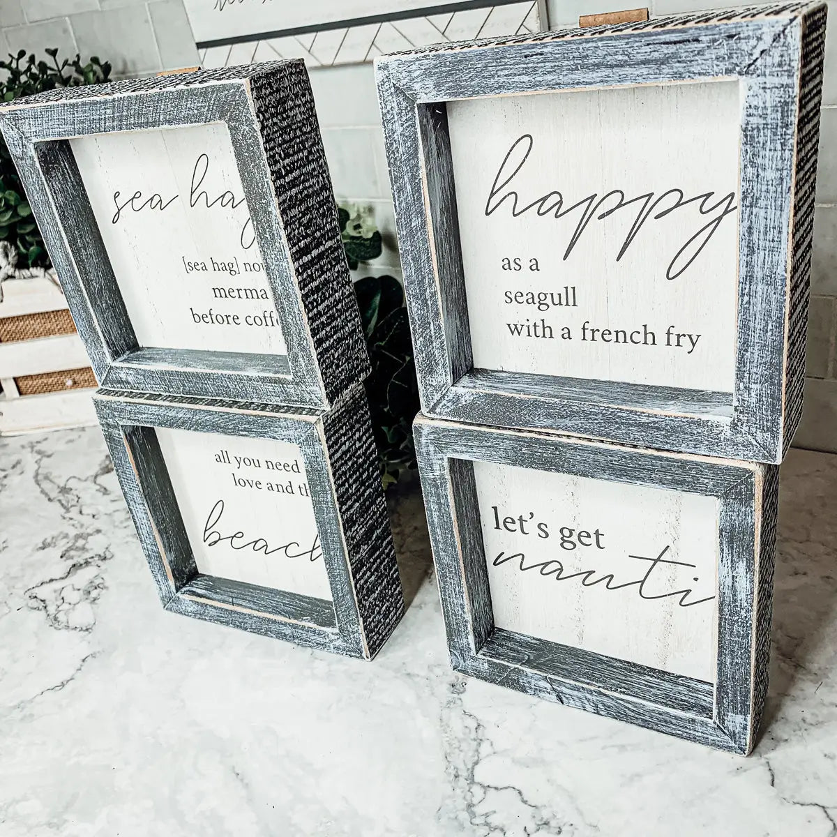 Set of wooden framed signs with text on a marble surface