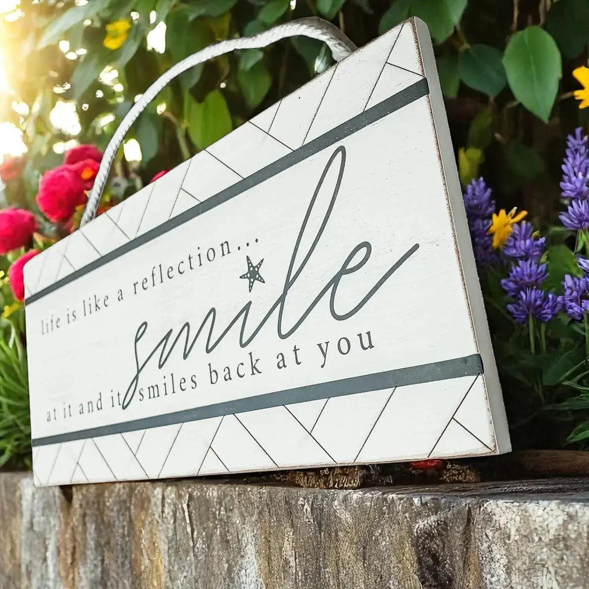 Decorative sign with motivational quote surrounded by flowers