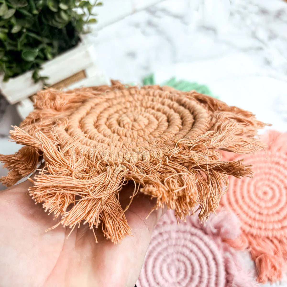 Round woven placemats with fringe on a blurred background