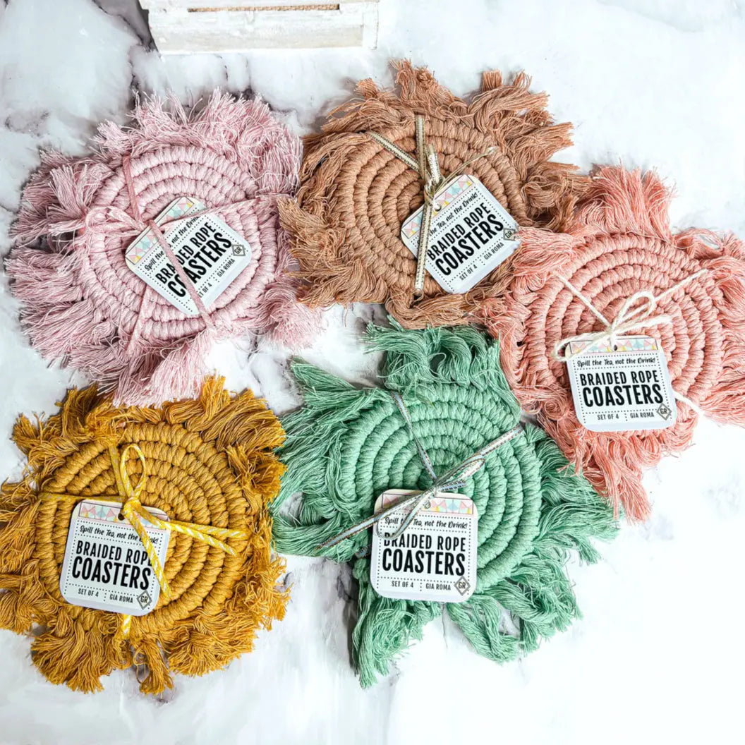 Set of braided rope coasters in various colors on a white background