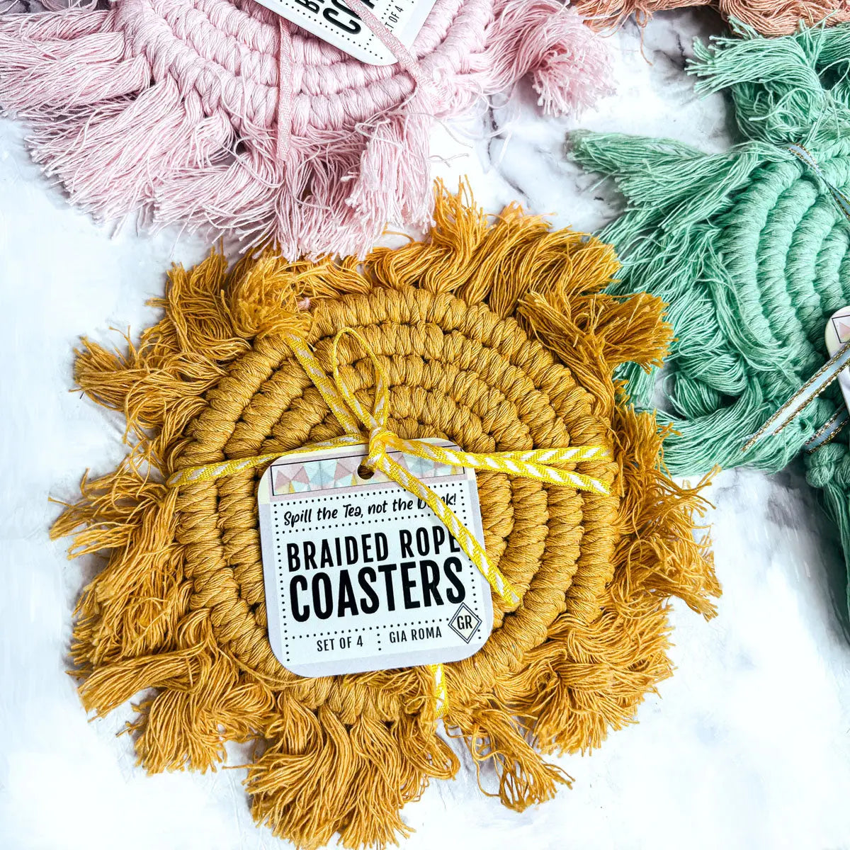 Yellow braided rope coaster with a label on a white background