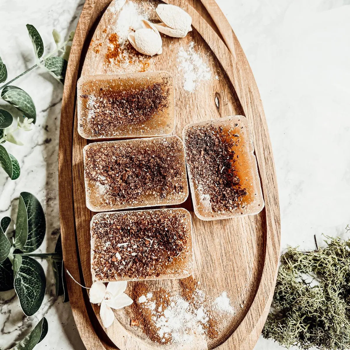 Wooden tray with rectangular brown and white patterned items on a light background