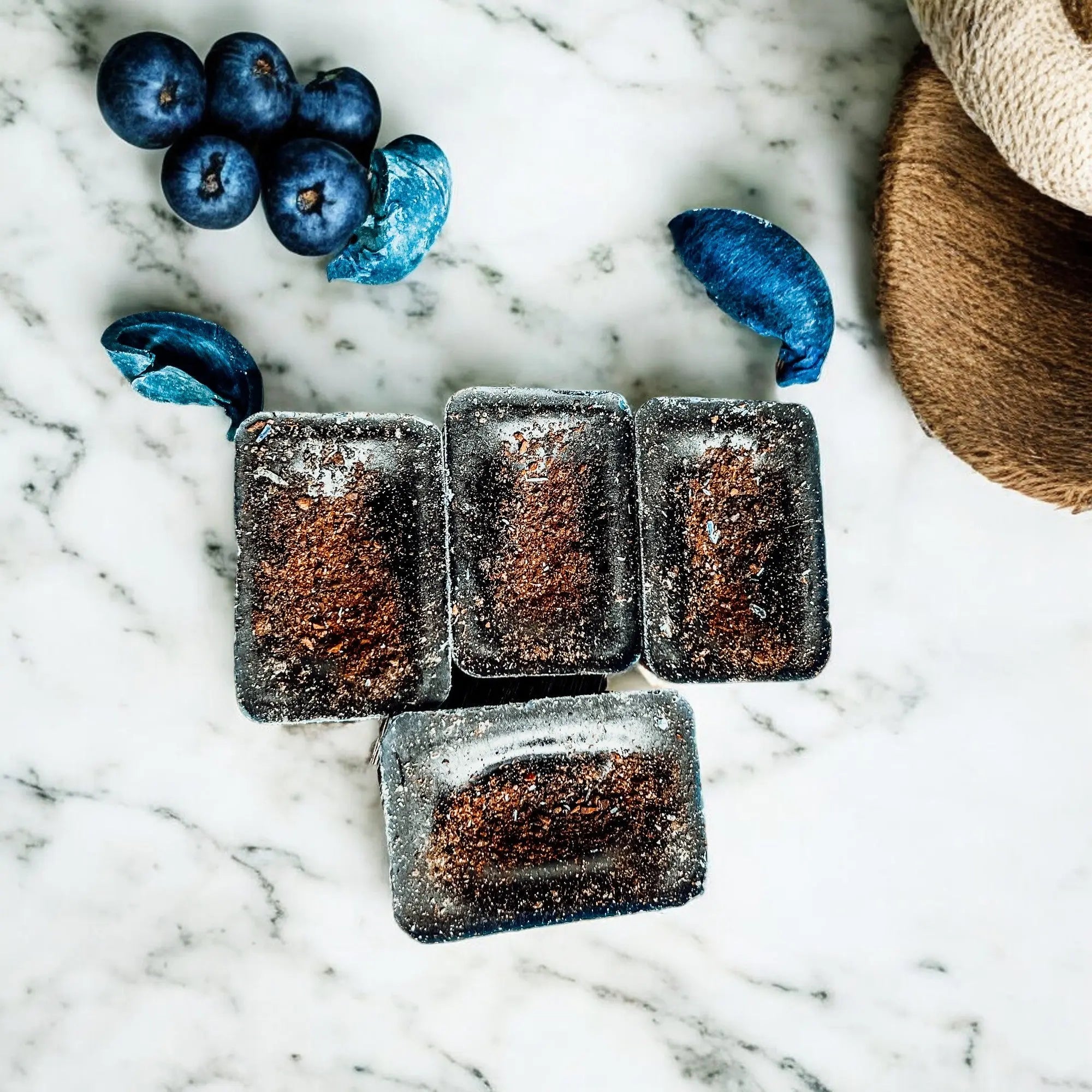 Chocolate truffles on a marble surface with blueberries