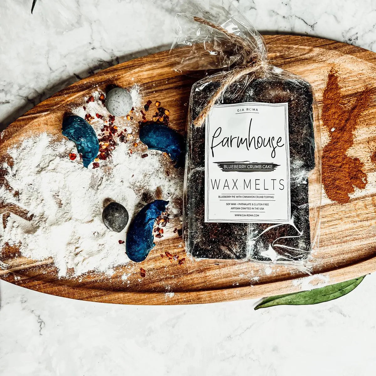 Pack of Farmhouse Wax Melts on a wooden board with decorative elements on a marble background