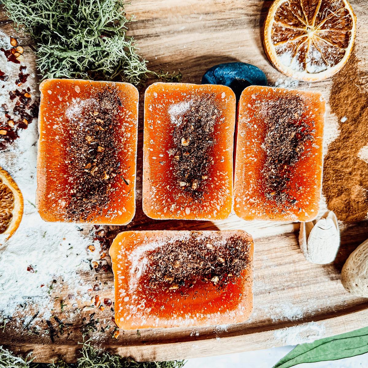 Four rectangular frozen desserts with a dark interior on a wooden board with decorative elements.
