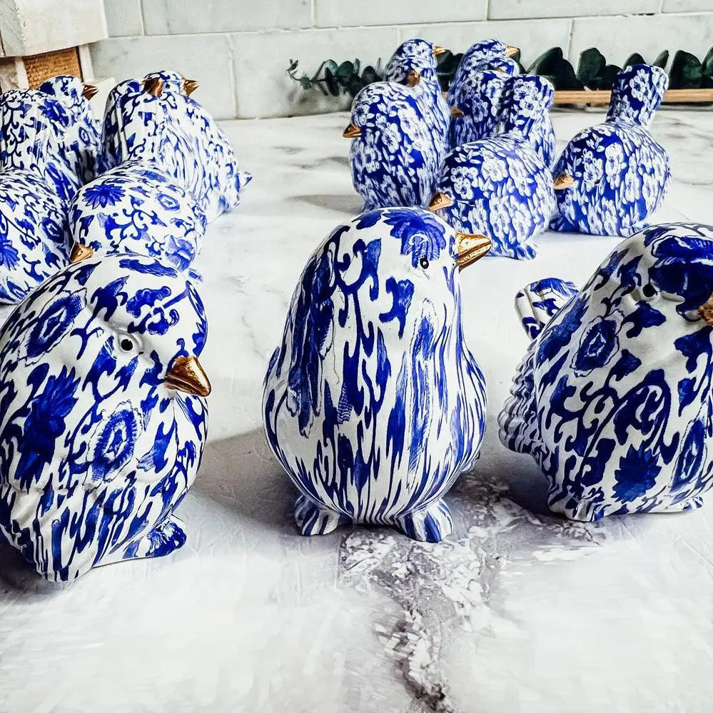 Blue and white ceramic penguins on a marble surface
