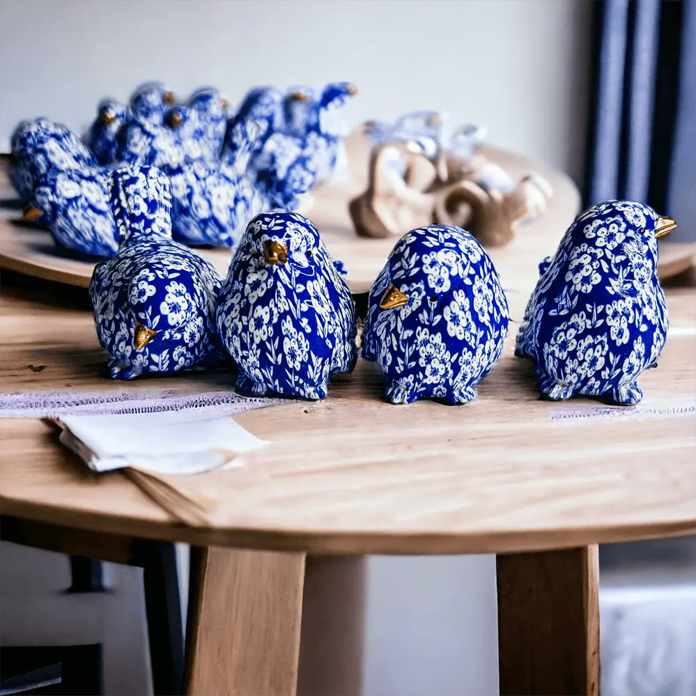 Blue and white ceramic birds on a wooden table