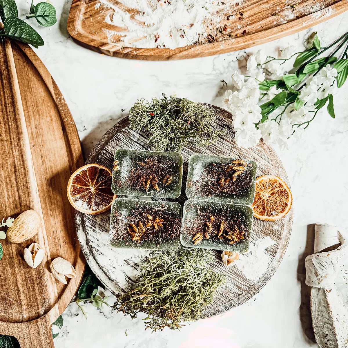 Herbal tea bags on a wooden board with dried herbs and oranges