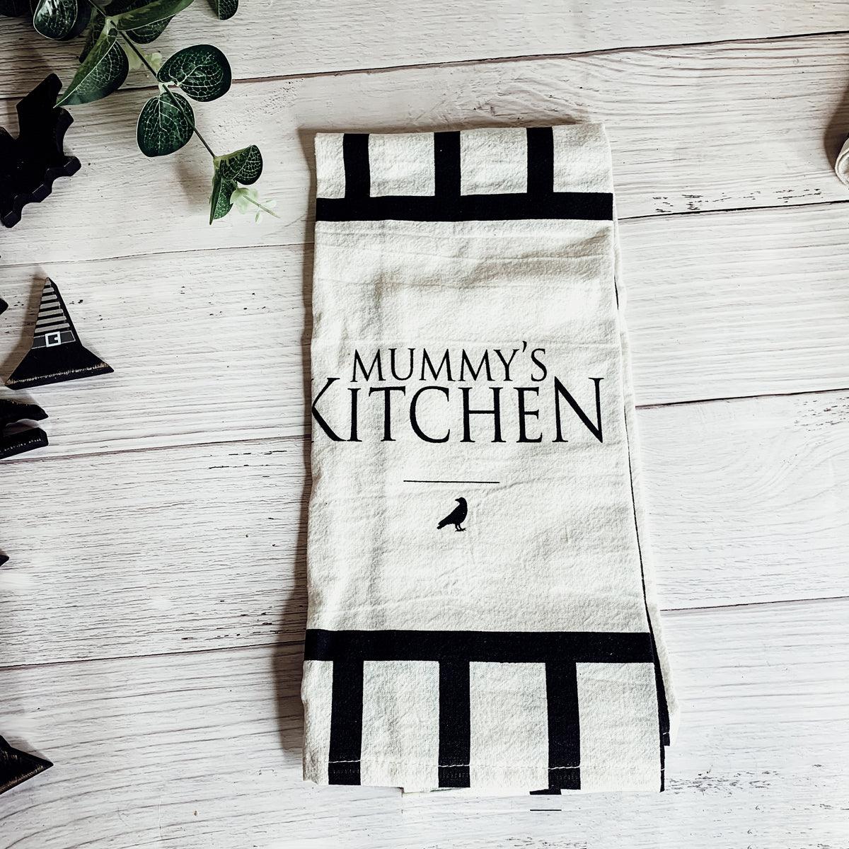 Kitchen towel with 'Mummy's Kitchen' text on a wooden surface
