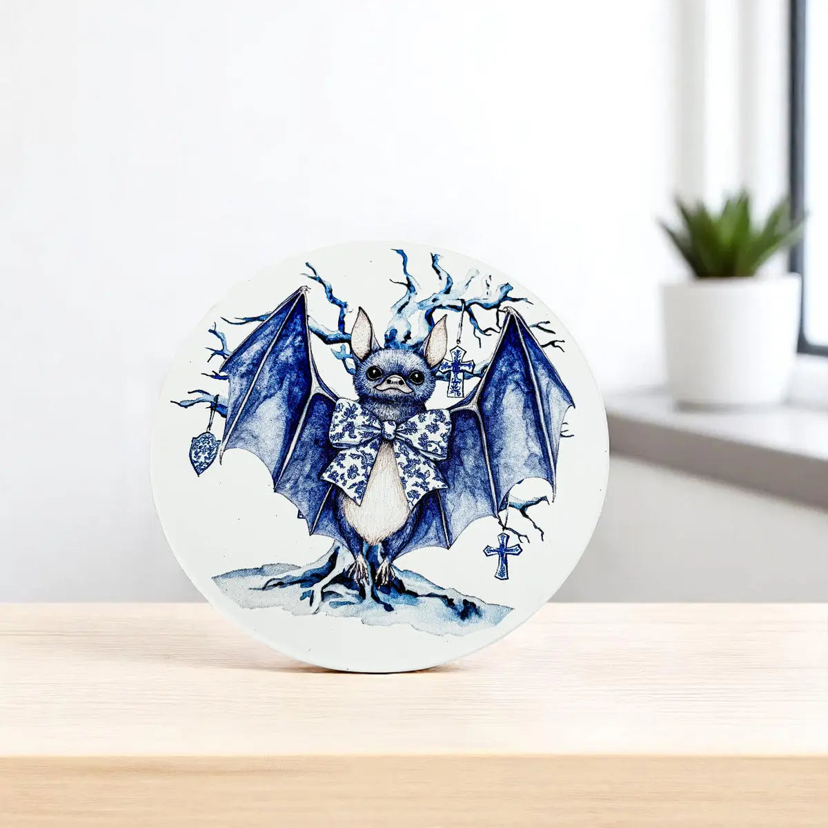 Decorative plate with a blue bat design on a white background