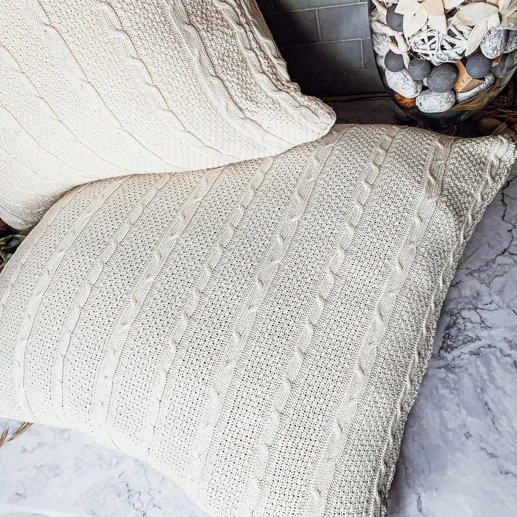 Cozy cable knit throw pillows in farmhouse style for warm, inviting home decor
