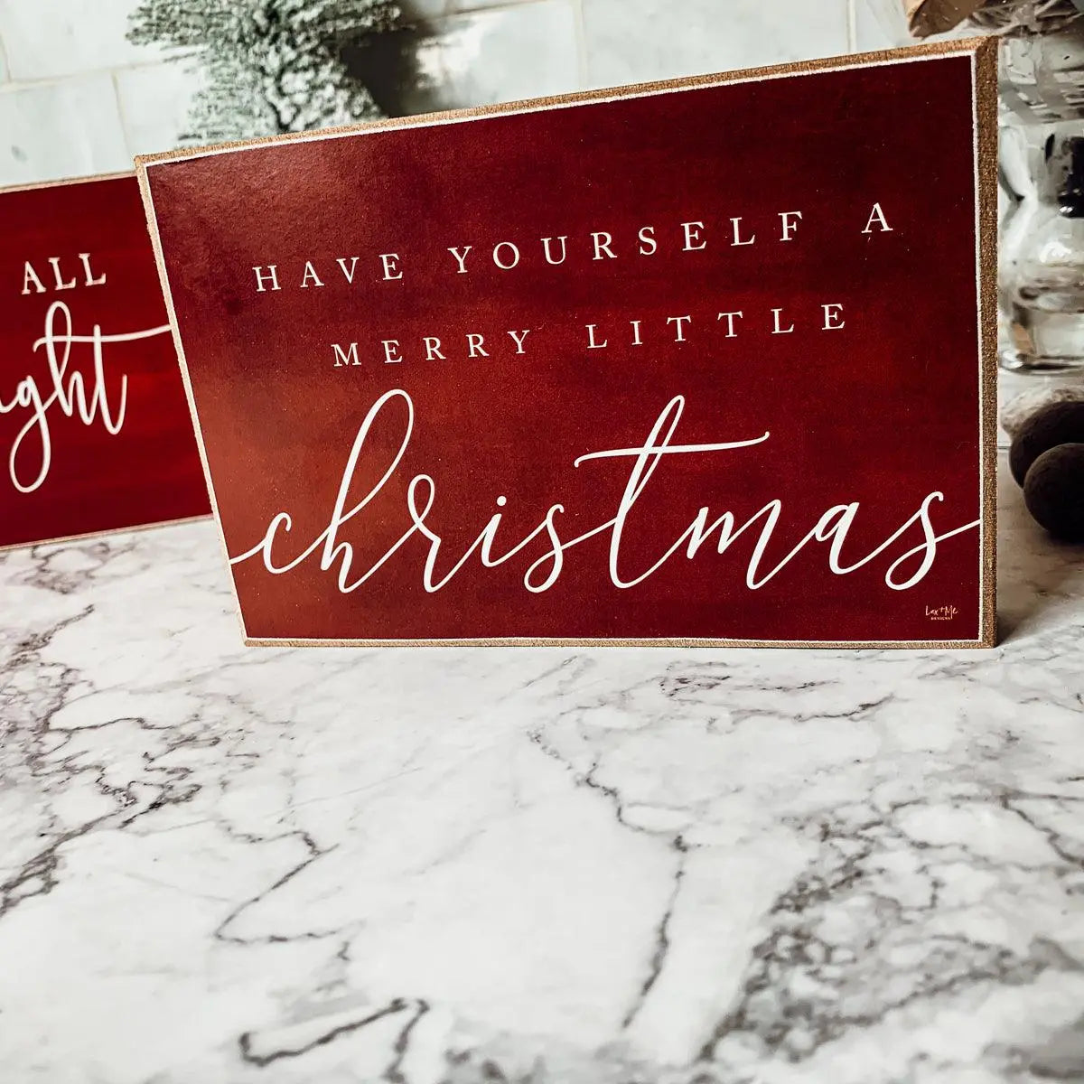Decorative Christmas sign with text on a marble surface