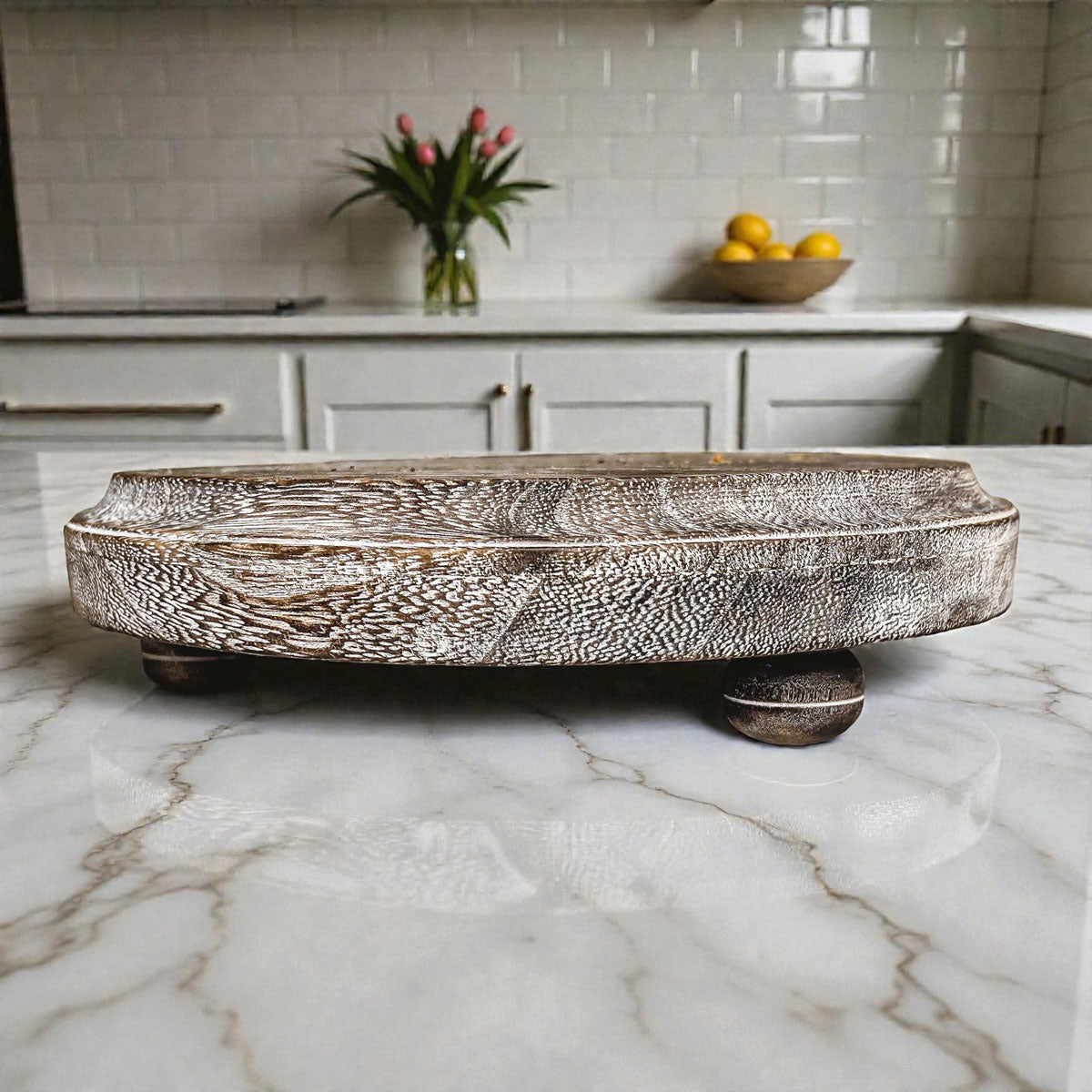 Decorative ceramic tray on a marble countertop with kitchen background