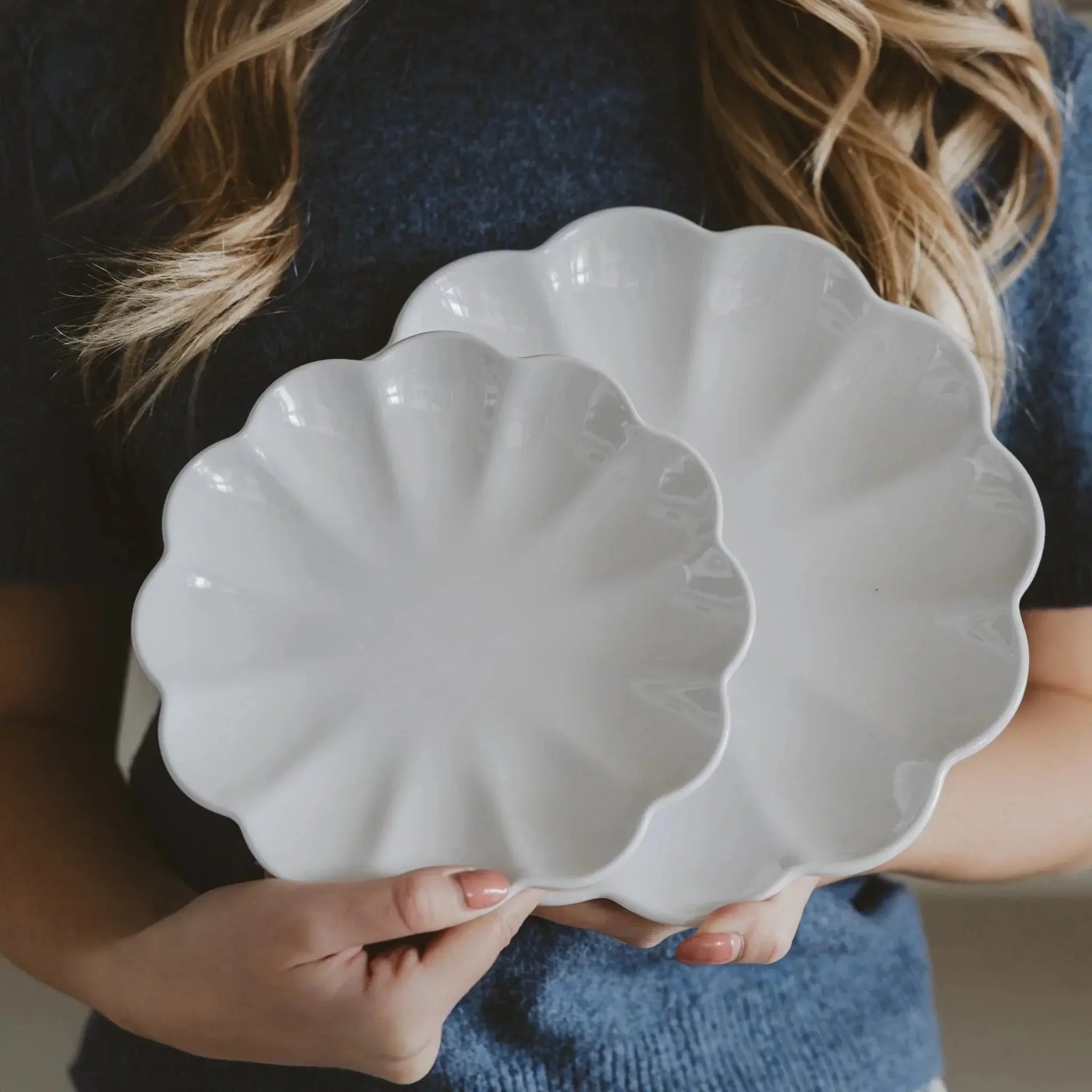 White scalloped ceramic plates for farmhouse cottage home decor, held by woman in cozy sweater