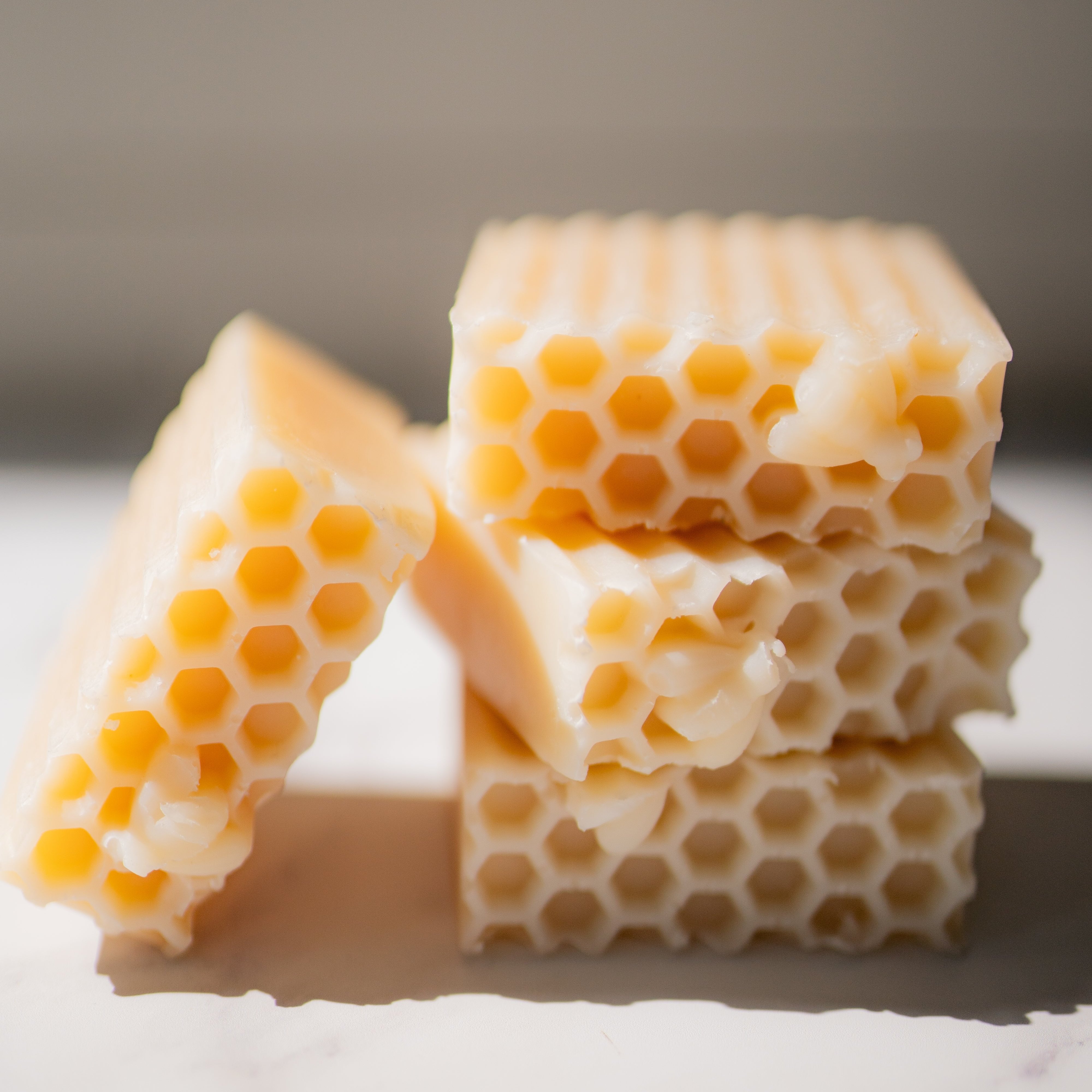 Close-up of honeycomb candy on a white surface with a blurred background