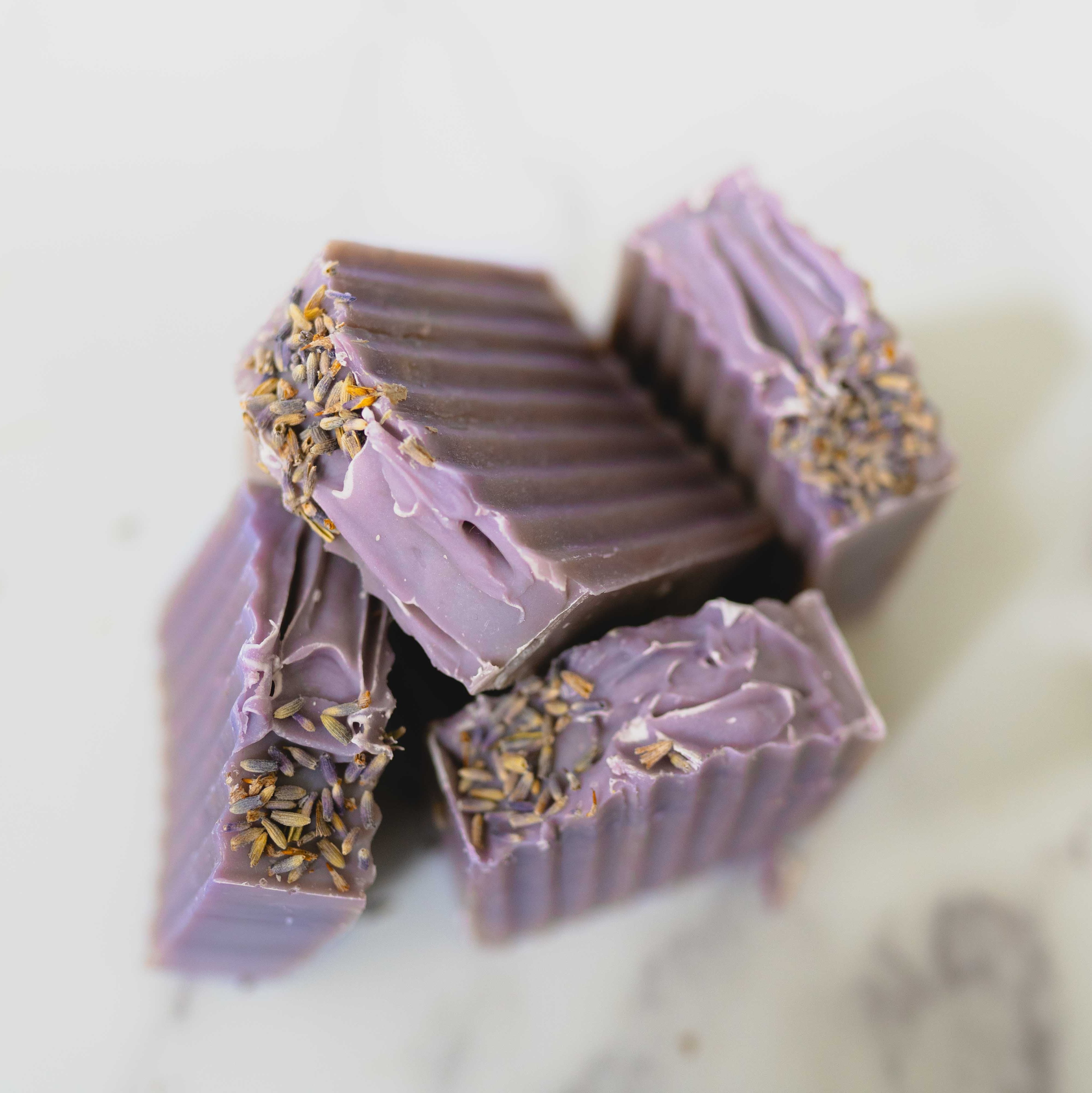 Purple chocolate bars with gold flakes on a light background