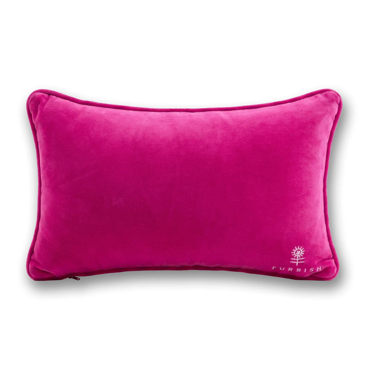 A rectangular magenta pink velvet lumbar pillow with piped edges and a small white embroidered logo in the bottom right corner, shown on a white background with a soft drop shadow.
