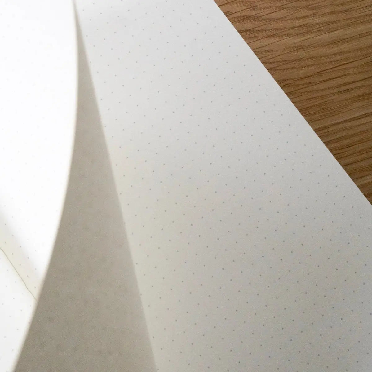 Close-up of a white textured sheet on a wooden surface
