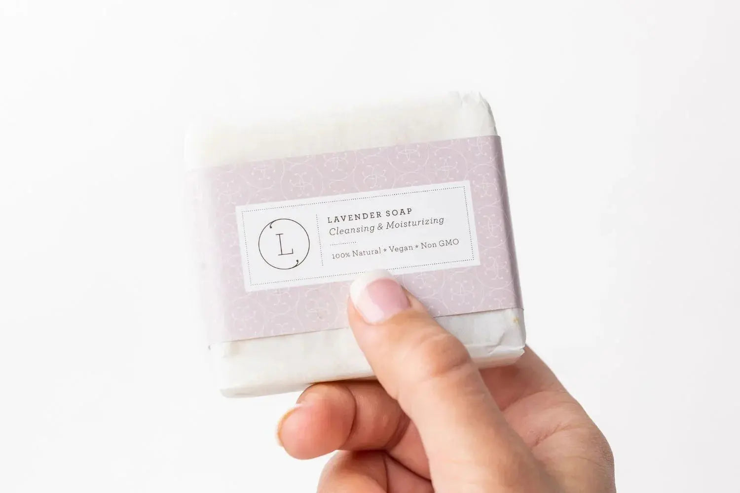 Lavender soap bar, natural vegan bath essential with cleansing & moisturizing benefits, held in hand
