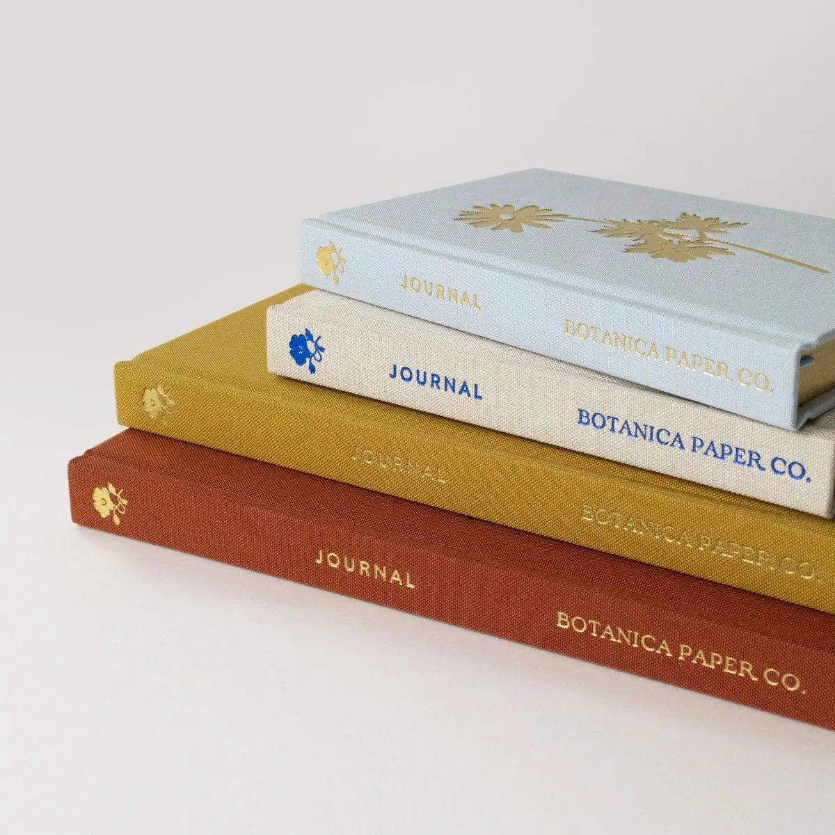 Three journals from Botanica Paper Co. stacked on a white background