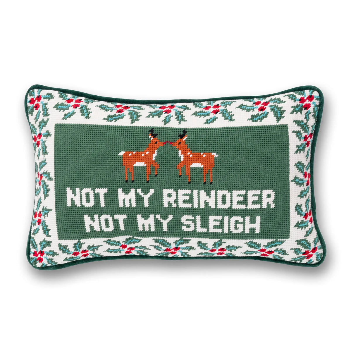 A rectangular Christmas needlepoint pillow with a dark green center panel featuring two orange reindeer facing each other and the text 'NOT MY REINDEER NOT MY SLEIGH' in white. The border has a white background with green holly leaves and red berries, and the entire pillow is outlined in dark green.