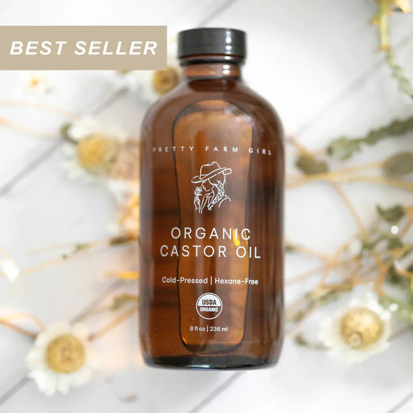 Organic castor oil in amber bottle, USDA certified, cold-pressed, hexane-free, best seller with dried flowers