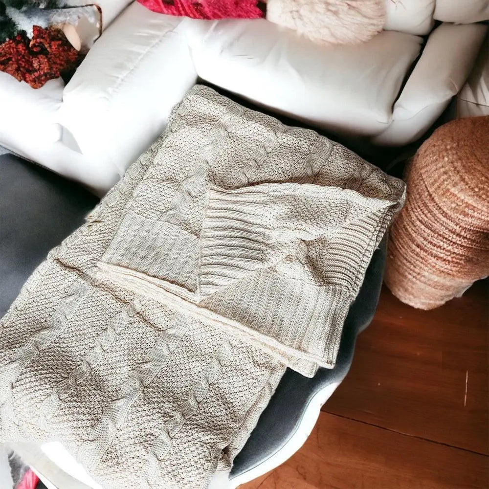 Cozy cable knit blanket on farmhouse-style sofa for warm, peaceful home decor