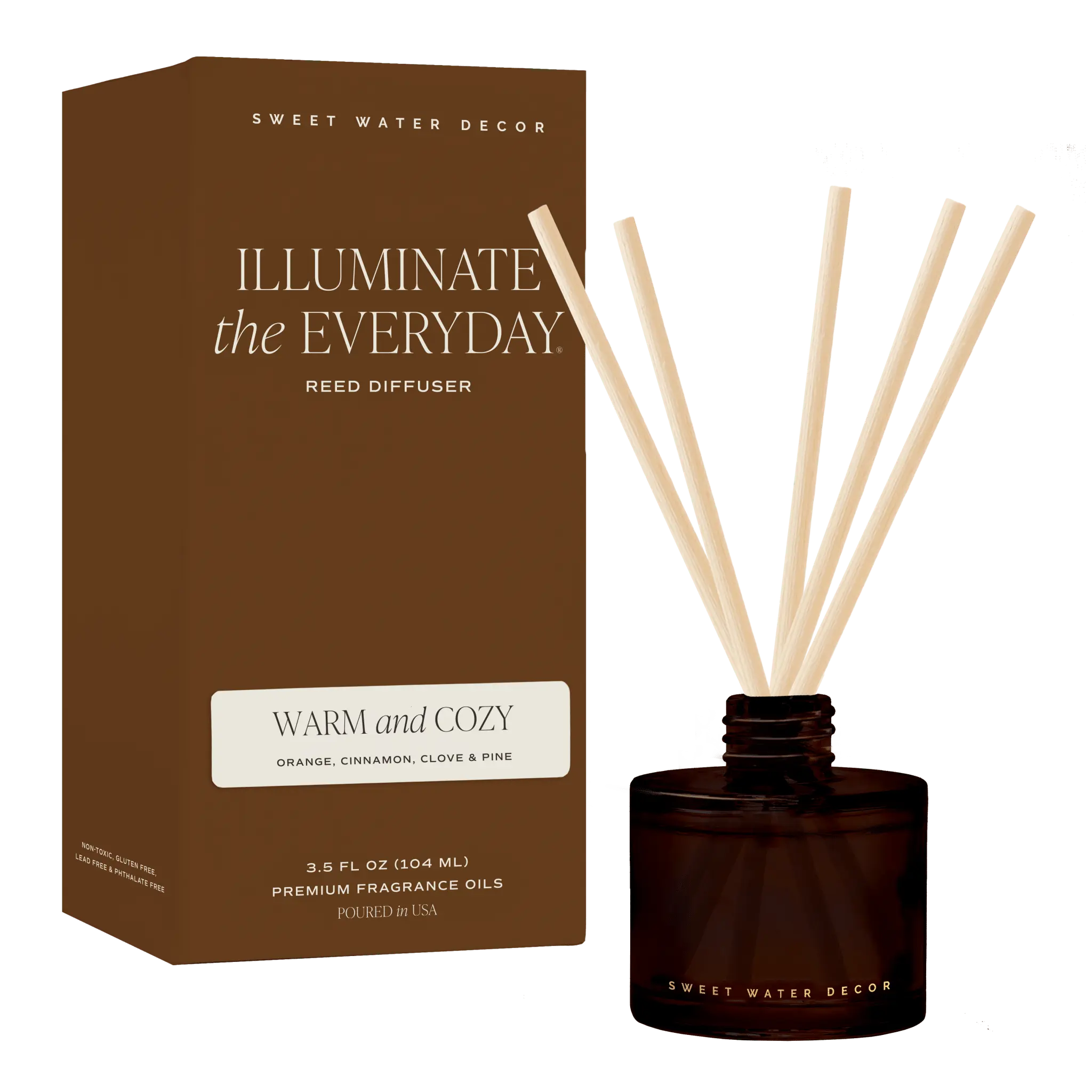 Sweet Water Decor 'Illuminate the Everyday' reed diffuser set, featuring a brown cardboard box and a dark amber glass bottle with cream-colored reeds, on a solid dark green background.