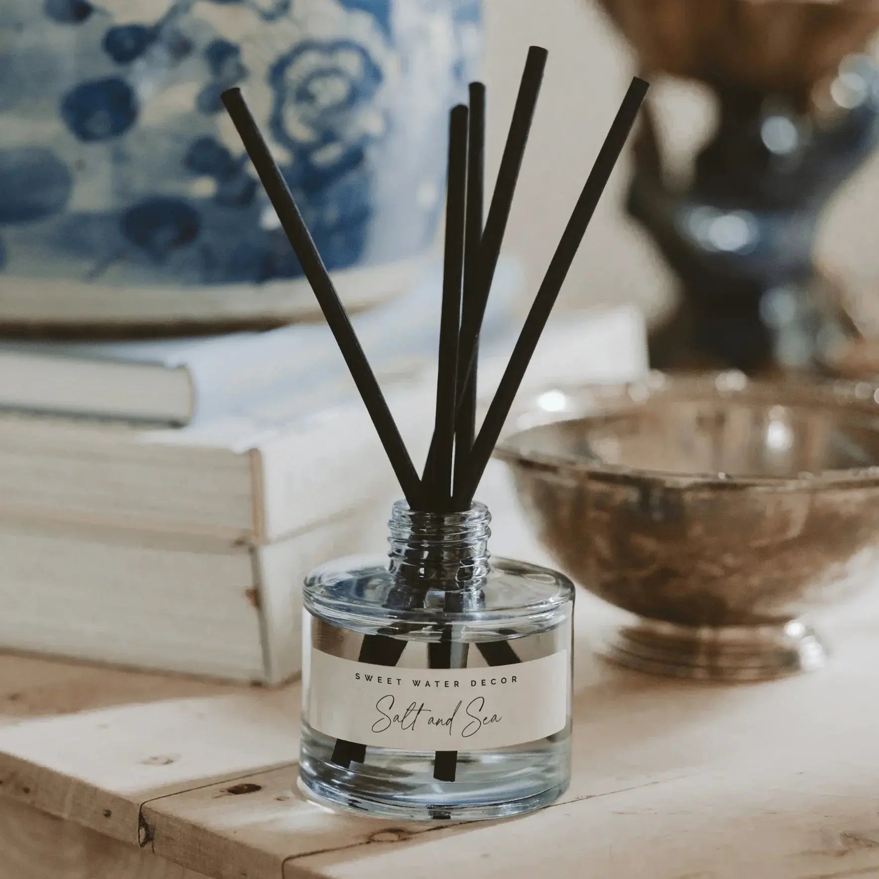 Salt and Sea reed diffuser in clear glass bottle with black reeds, cozy farmhouse home decor