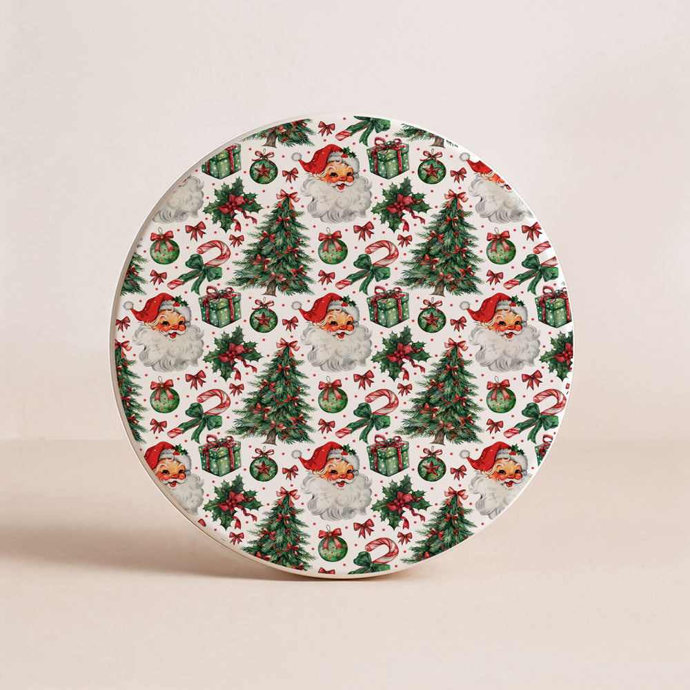 Decorative plate with Christmas-themed design featuring trees, presents, and dogs in Santa hats on a beige background.