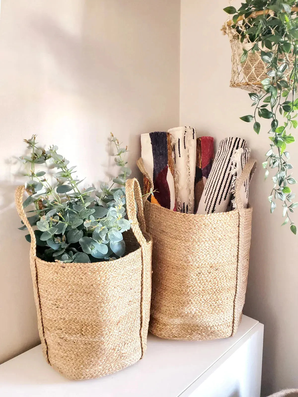 Woven jute baskets with eucalyptus and patterned textiles, cozy farmhouse decor