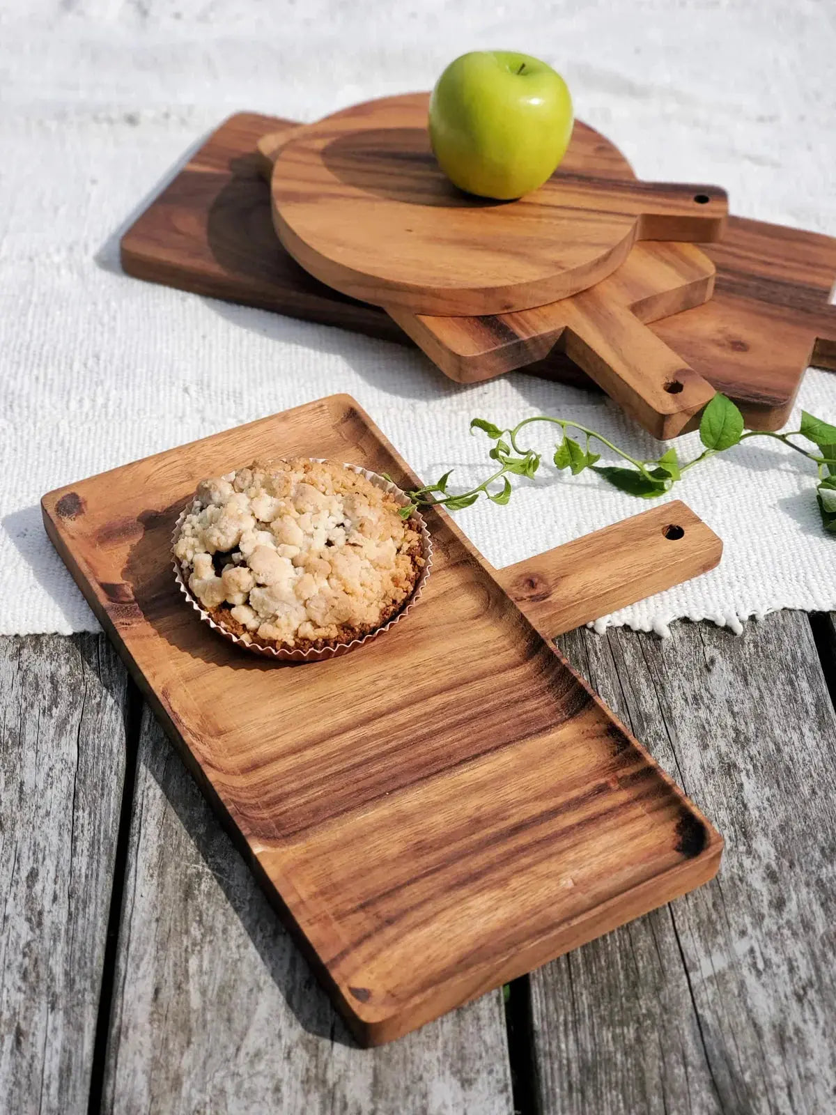 Rustic wooden serving trays with apple pie and green apple, farmhouse kitchen decor