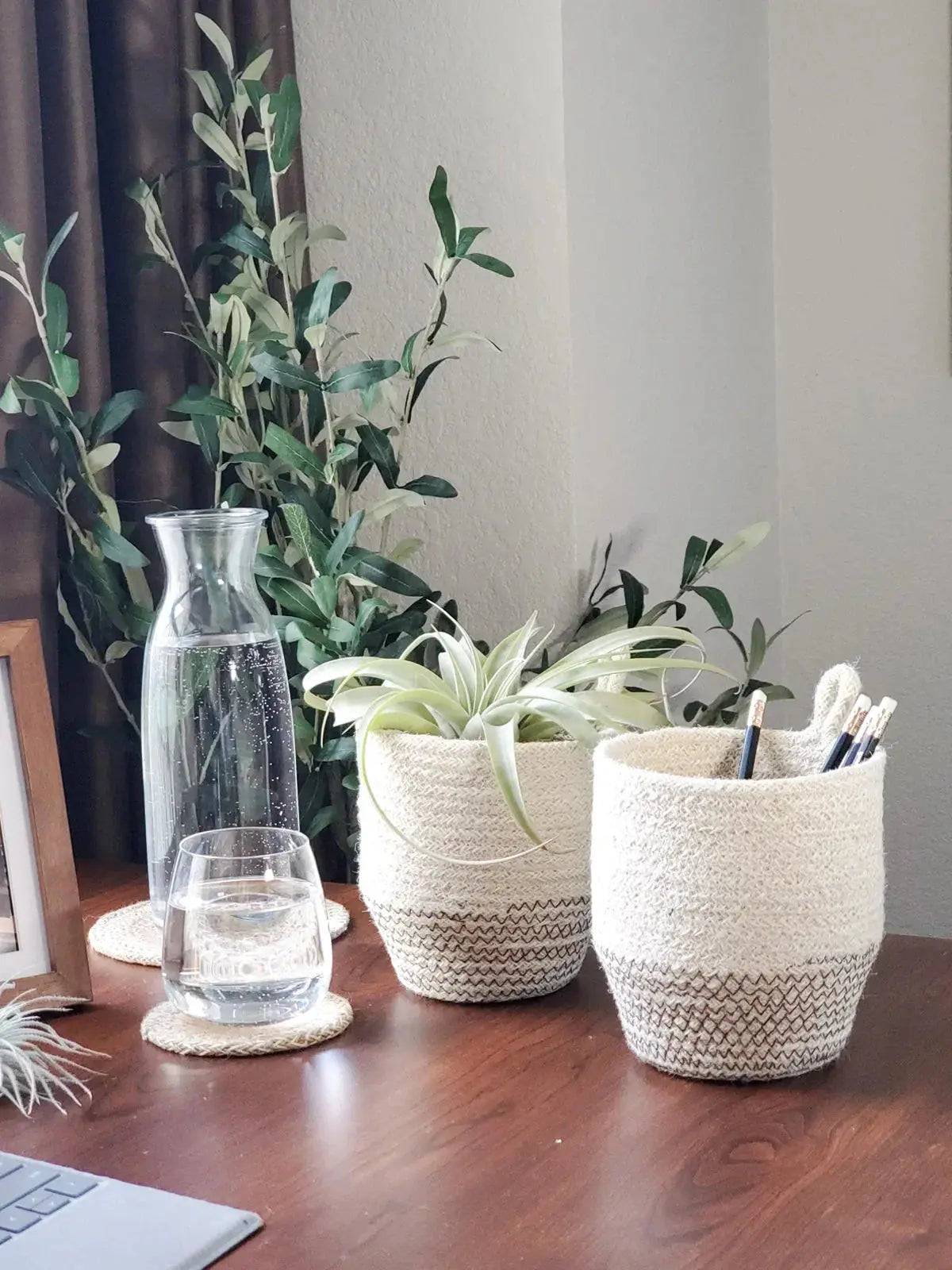 Woven jute desk organizers with air plant and pencils, cozy farmhouse home decor on wood table