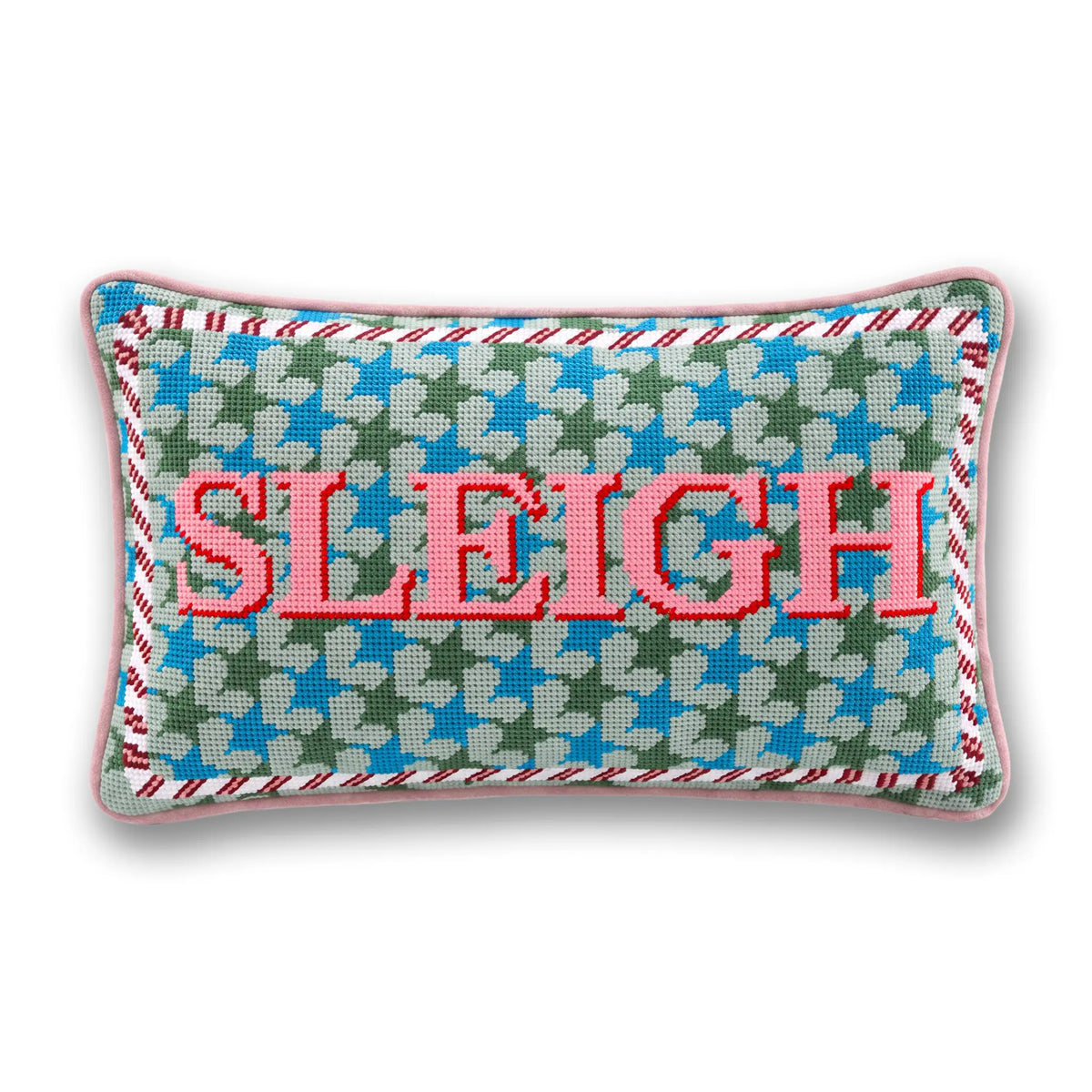 A rectangular needlepoint pillow featuring the word 'SLEIGH' in red letters over a green, blue, and white star pattern, with a pink stitched border.