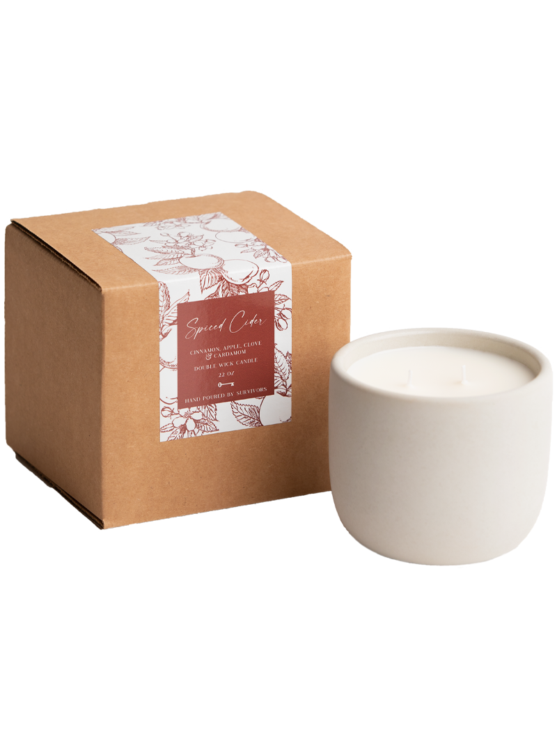 Ceramic candle in a cardboard box with a label on a white background
