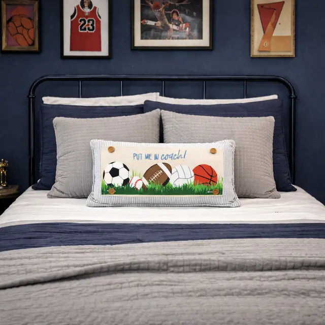 Bedroom with sports-themed decor, including framed pictures and sports balls on a pillow.