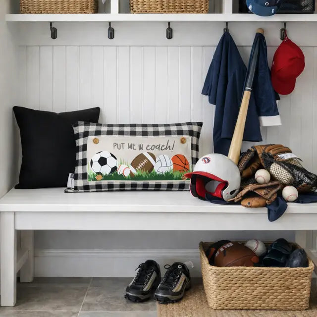 Mudroom with sports-themed decor including a bench, pillows, and sports equipment.